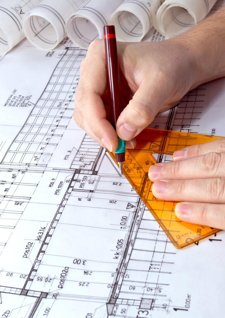 Architect drawing rolls and plans blueprints project Architect drawing rolls and plans blueprints project